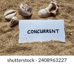 Small photo of Concurrent writing on beach sand background.