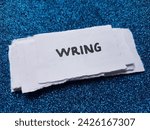Small photo of Wring writting on blue background.