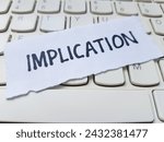 Small photo of Implication writting on laptop keyboard background.