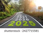 New year 2025 or straight road concept. Text 2025, 2026, 2027 written on the road in the middle of the asphalt road at sunset. Concept of planning, goals, challenges, new year resolutions.