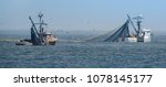 Small photo of Monterey, California - April 23, 2018: Commercial squid fishing boats work around the clock, including daylight hours, using purse seine nets as squid return to the waters of the Monterey Bay.