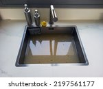 Small photo of Overflowing kitchen sink, clogged drain. Plumbing problems.