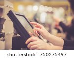 Young woman hands counting / entering discount / sale to a touchscreen cash register, market / shop (color toned image)