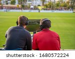 commentators on football game watching match. stream for television and radio