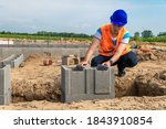 building the foundation of a building with lost formwork by a young construction engineer
