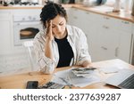 Small photo of Stressed caucasian woman trying to deal with financial documents, having problem to find money to pay utility bills or loans. The concept of debt, bankrupt. Accounting companies advertisement mockup