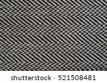 Small photo of Herringbone (Broken Twill Weave) - a distinctive V-shaped weaving pattern. Closeup. Grey textured background.