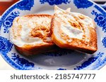 Small photo of Eggy bread on the plate, photographed with natural light. Golden French toast with butter and egg. breakfast with bread. English breakfast. healthy breakfast with eggs