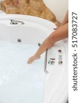 Small photo of White whirlpool bath with rock ready to take a bath.