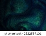 Small photo of Abstract sparkling galaxy background. Golden glitter particles on a dark blue background with green hues. Golden dust particles magical stains and flows.