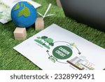 Small photo of Corporate business company plan and research paper on reducing CO2 emission and carbon credit by renewable clean energy technology utilization on meeting table as hub of eco innovative idea. Quaint