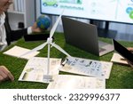 Small photo of Diverse group of business people planning for alternative energy utilization for greener sustainable Earth by reducing CO2 emission and carbon credit with renewable clean energy technology. Quaint
