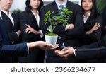 Small photo of Eco-friendly investment on reforestation by group of business people holding plant together in office promoting CO2 reduction and natural preservation to save Earth with sustainable future. Quaint