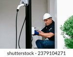 Small photo of Qualified technician install home EV charging station, providing maintenance service for electric vehicle's battery charging platform at home. EV car technology for residential utilization. Synchronos