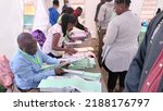Small photo of NAIROBI, KENYA- AUGUST 8, 2022: Independent Electoral and Boundaries Commission (IEBC) polling clerks process voters in Kasarani Constituency during the General Election.