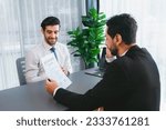 Small photo of Interviewing job applicant in office with resume paper. Candidate wear suit for formal conversation with interviewer. Recruitment process with question about career and work experience. Fervent