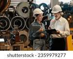 Small photo of Factory engineer manager with assistant using laptop to conduct inspection of steel industrial machine, exemplifying leadership as machinery engineering inspection supervisor in metalwork manufacture.