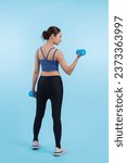 Small photo of Vigorous energetic woman doing dumbbell weight lifting exercise on isolated background. Young athletic asian woman strength and endurance training session as body workout routine.