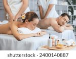 Small photo of Caucasian couple customer enjoying relaxing anti-stress spa massage and pampering with beauty skin recreation leisure in day light ambient salon spa at luxury resort or hotel. Quiescent