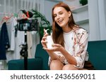 Small photo of Woman influencer shoot live streaming vlog video review makeup utmost social media or blog. Happy young girl with cosmetics studio lighting for marketing recording session broadcasting online.
