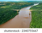 Small photo of Aerial view of The Tancredo Neves Bridge, better known as Fraternity Bridge connecting Brazil and Argentina through the border over the Iguassu River, with the Argentinian city of Puerto Iguazu