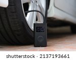 Small photo of Portable cordless tire inflator. Portable air pump