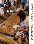 Small photo of Jerusalem/Israel-June 10,2019: The stone of unction at the Holy Sepulchre greets the visitors, who kneel, pray and kiss the stone. Above the stone are lamps, each donated by one of the denominations.