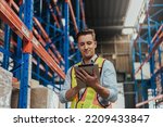 Warehouse Workers checking stock with digital Tablet in Logistic center. Caucasian manager wearing safety vests to working about shipment in storehouse, Working in Storage Distribution Center.