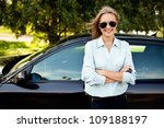 Young woman standing next to her new car
