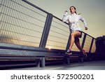 Athletic woman running during...