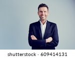 Happy businessman isolated - handsome man standing with crossed arms