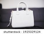 Little white handbag on grey background 