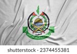 Small photo of Hamas Coat of arms - Logo of Hamas on real fabric textured flag - officially the Islamic Resistance Movement. Palestine Hamas Flag. Gaza Strip of the Palestinian territories.