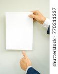 man hand holding white paper a4 ... | Shutterstock . vector #770211337