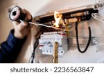 Small photo of Electrician working on a Australian Power Distribution Board and Installing New Breakers on a Breaker Panel