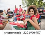 Woman relaxing at tailgate barbecue in field