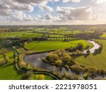 Aerial view over Arthington Viaduct and the River Wharfe on a sunny autumn day. Meandering river bends through the North Yorkshire countryside. UK