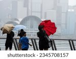Small photo of Hong Kong - August 10th 2023: Typhoon Teli hit Hong Kong, and citizens chased the wind on the bank of Victoria Harbor, Hong Kong.