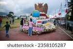 Small photo of TOMOHON, INDONESIA – AUGUST 20, 2023: Tomohon International Flower Festival - TIFF, Cars decorated with flowers to take part in the tournament of flower