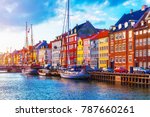 Scenic summer sunset view of Nyhavn pier with color buildings, ships, yachts and other boats in the Old Town of Copenhagen, Denmark