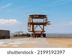 Small photo of WESTON-SUPER-MARE, UK, JULY 13, 2022: Having been unloaded onto the beach, See Monster waits to be moved nearer to the Tropicana