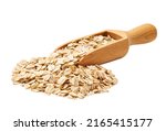 wooden spoon or scoop with raw oatmeal flakes seen isolated on white background. oatmeal granola in a wooden spoon .