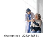 Small photo of Young asian caretaker with 60s asia elderly woman consulting and encourage, take a history and recommend the right treatment, holding hands and encouraging