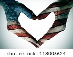 man hands painted as the american flag forming a heart