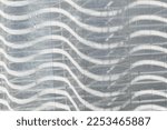 Small photo of Side view of full curtain frame with squiggly lines. Light-shadows. Photography