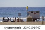 Small photo of Playa del Ingles, Maspalomas, Gran Canaria, Canary Islands, Spain - July 27th 2023 - Yellow flag on the lifeguard tower indicating caution to bathers of Maspalomas beach and Playa del Ingles