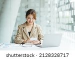 Small photo of Smiling Young Asian Business women working with calculator, business document and laptop computer notebook,financial inspector and secretary making report,Internal Revenue Service checking document.