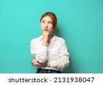 Small photo of Portrait of thoughtful smart asian woman thinking, female student solving puzzled, look up complicated or pondering, touch chin while trying made up idea, daydreaming over blue background.