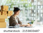 Small photo of Portrait young attractive asian female owner startup business work happy with box at home prepare parcel delivery in sme supply chain, start up small business concept.