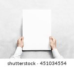 Small photo of Hand holding white blank poster mockup, isolated. Arm in shirt hold clear broadsheet template mock up. Affiche bill surface design. Broadside pure print display show. Sticking a3 poster on the wall.